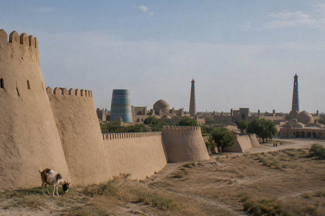 An ancient walled city with mud brick walls and minarets under a wide desert sky