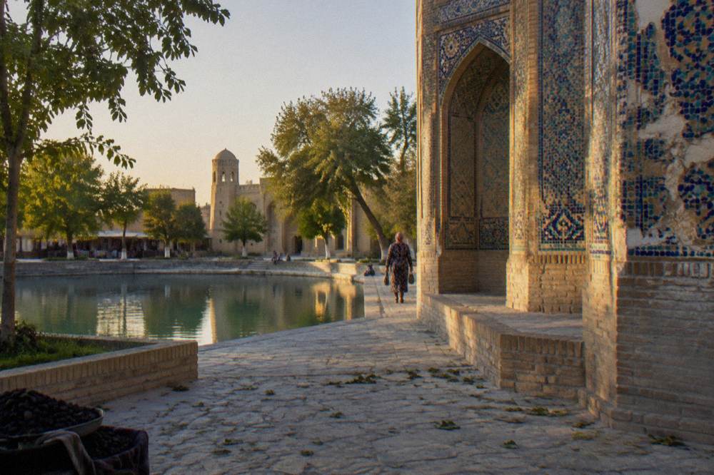 Ornate tiled facade of a historic Bukhara monument with geometric patterns in blue and turquoise