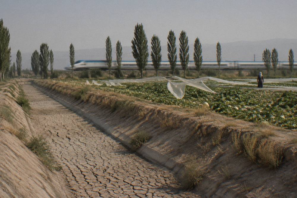 Modern high-speed train traveling through open countryside toward Samarkand