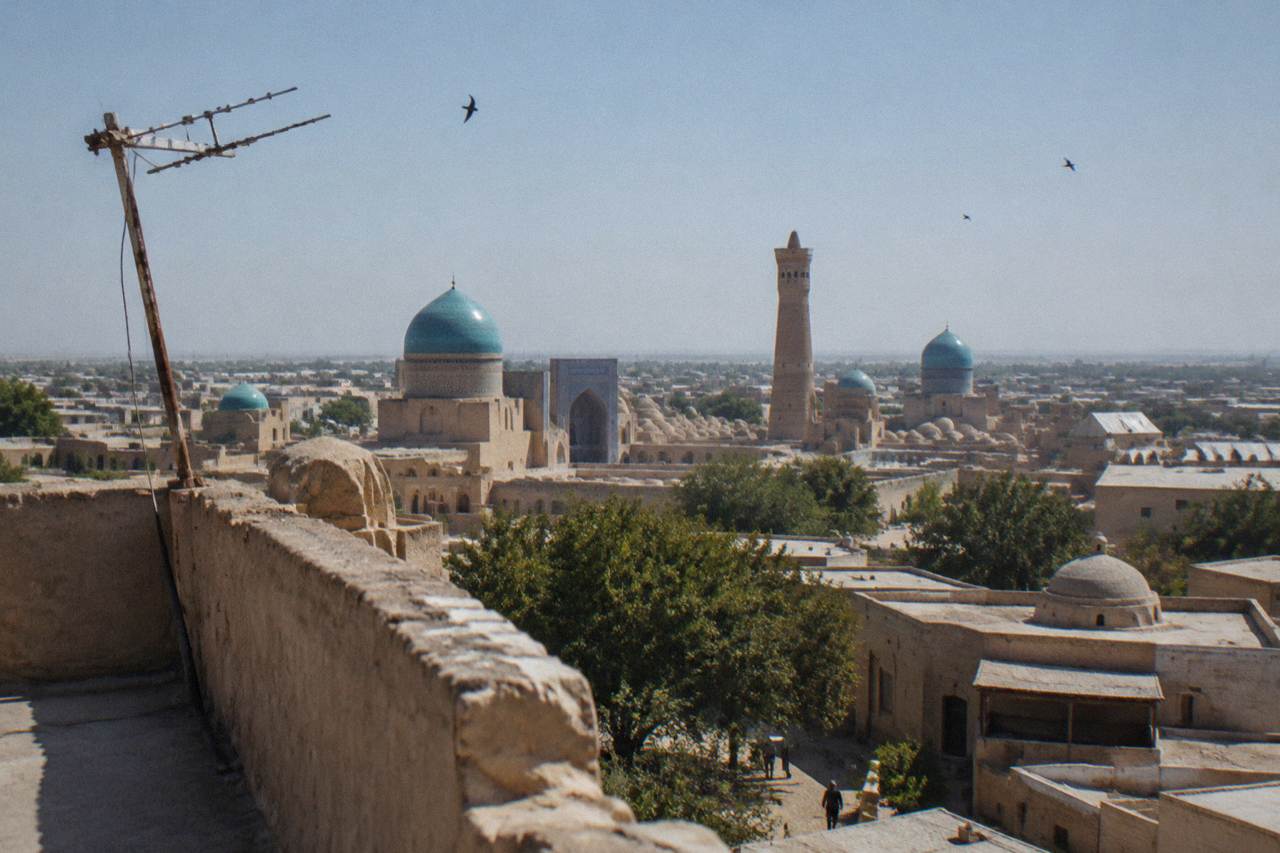 Blue tiled domes and minarets of a medieval Silk Road city under a clear sky