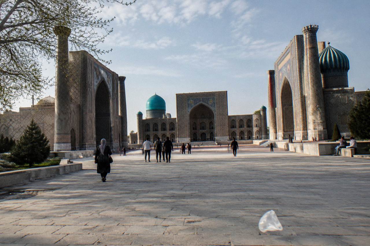 The tiled facades and blue domes of the Registan ensemble in Samarkand under a clear sky
