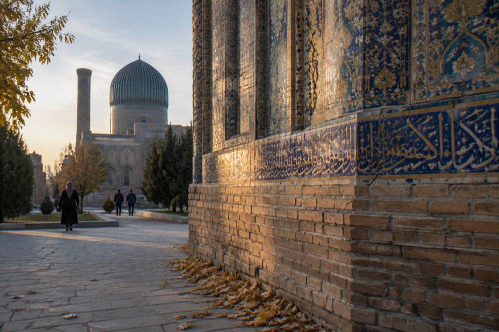 Close view of intricate blue and gold tilework on the wall of a Samarkand monument