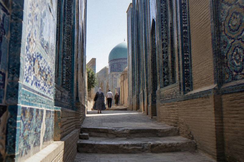 Shah-i-Zinda necropolis in Samarkand, a narrow passage lined with blue-tiled domed mausoleums