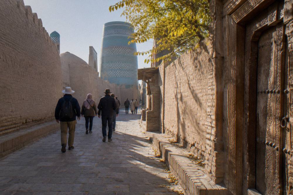 A small tour group walking together through a narrow stone lane of a walled old city