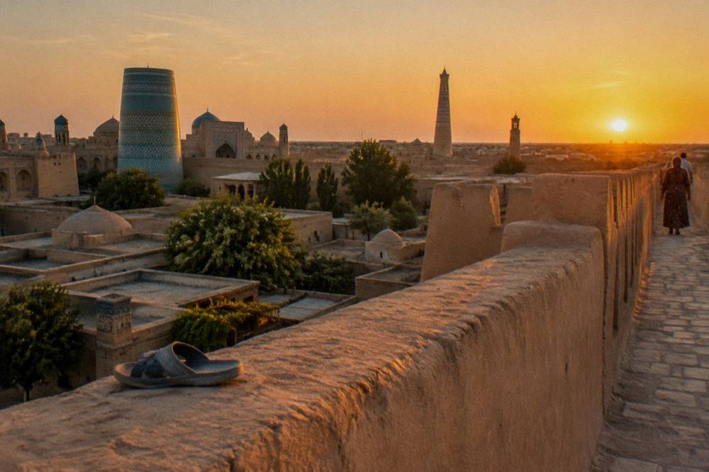 A mud brick walled old town at golden hour with minarets rising above narrow streets