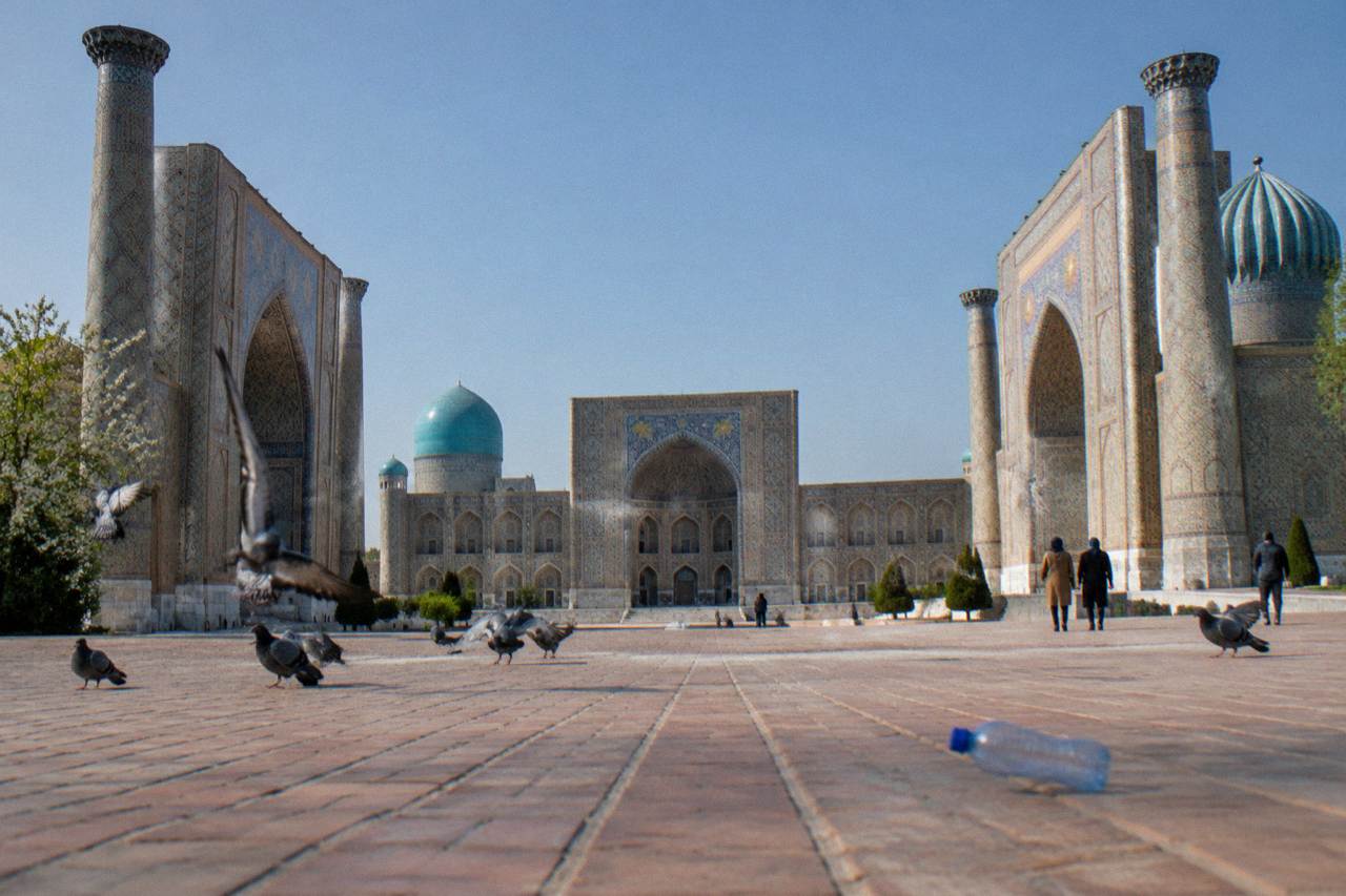 The three tiled facades of the Registan ensemble in Samarkand under a clear sky