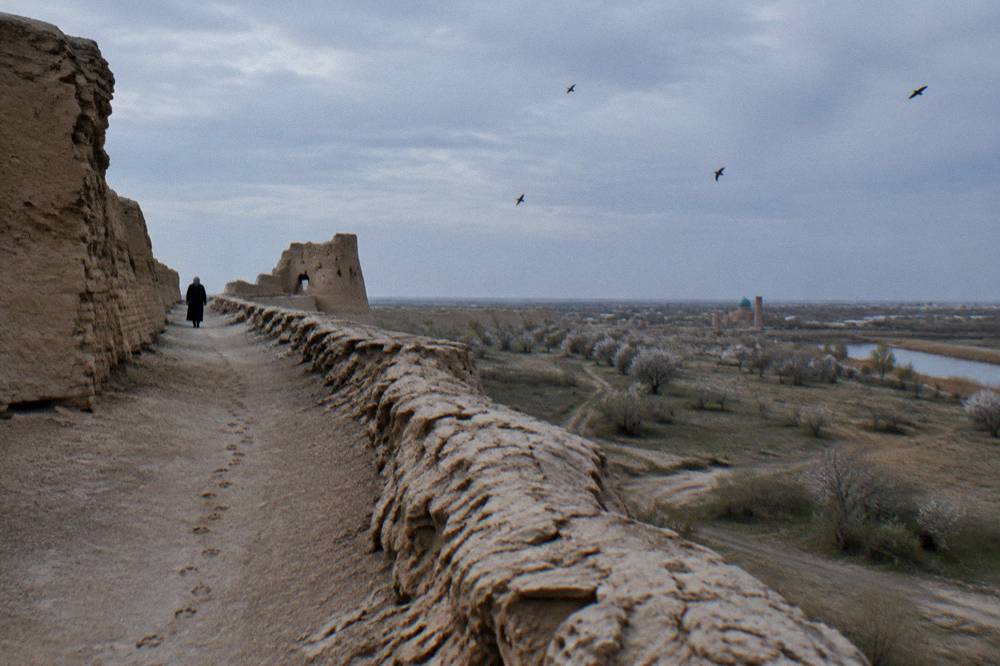 Ancient mud brick fortress walls standing alone on an empty desert plain