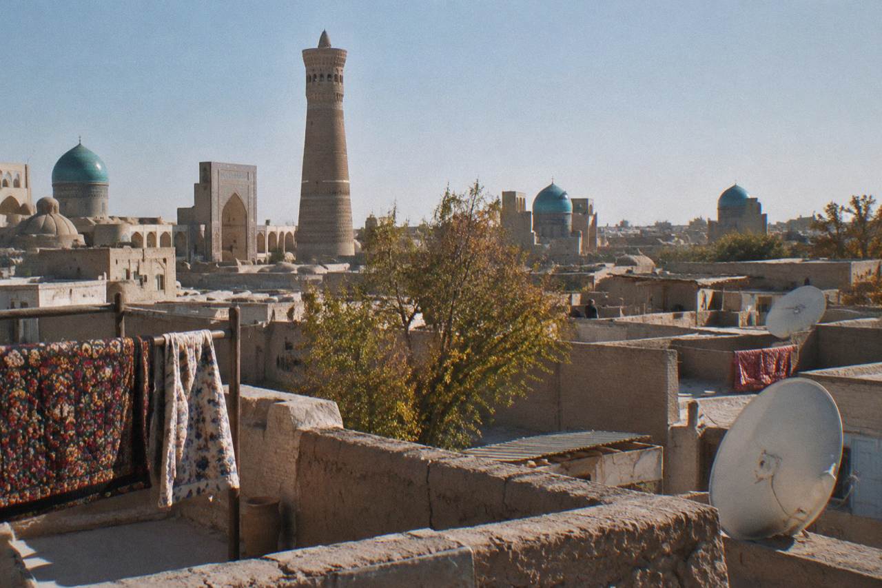 Blue tiled domes and minarets of a historic Silk Road city under a clear sky