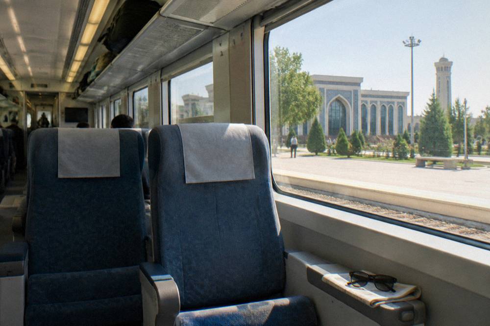 Interior of a high speed train carriage with seats and large windows in Uzbekistan