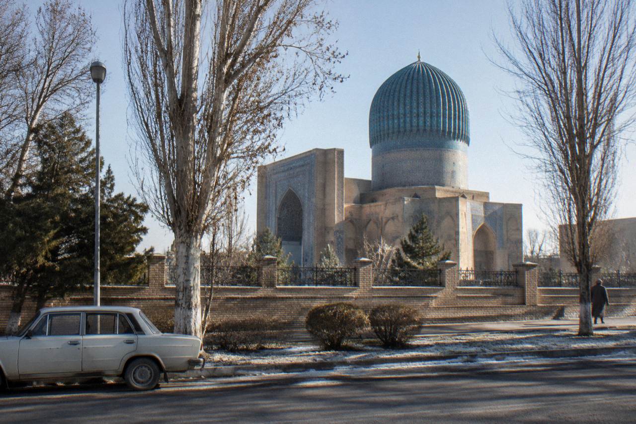 Blue tiled dome of a Silk Road monument under a clear sky in Samarkand