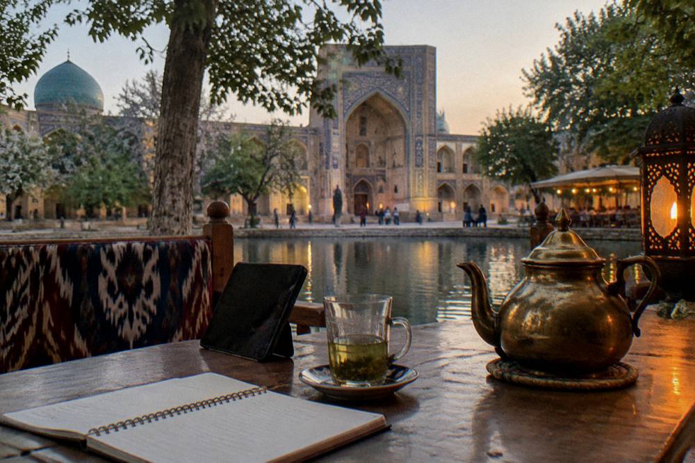 Traveler notebook and phone on a cafe table with a tiled courtyard in the background